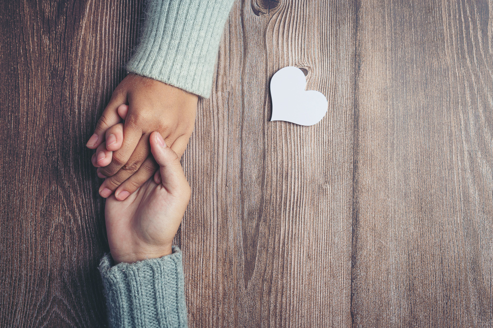 two people holding hands together with love